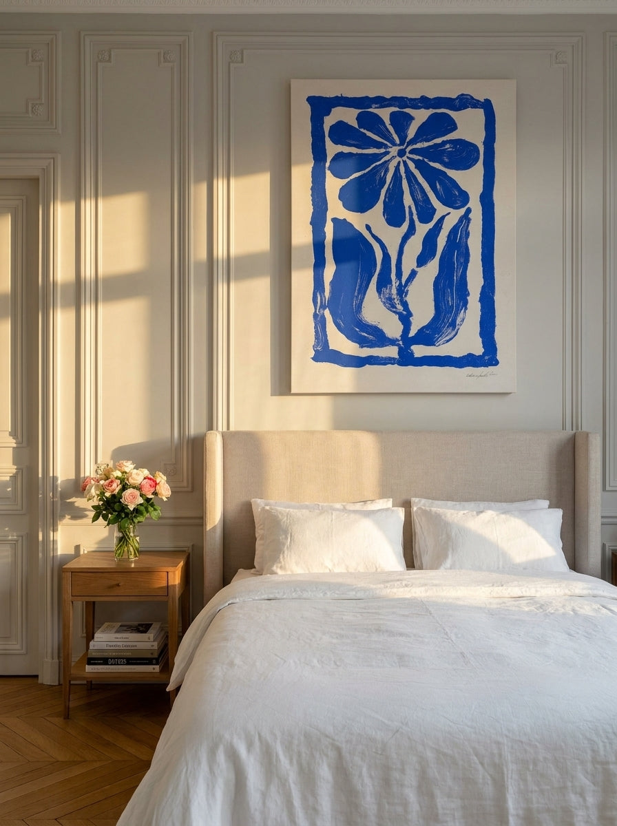 Stretched canvas wall art styled on the wall in a Parisian bedroom