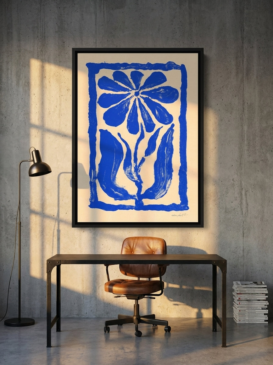 Canvas wall art with a black surround styled on the wall in an industrial loft home office