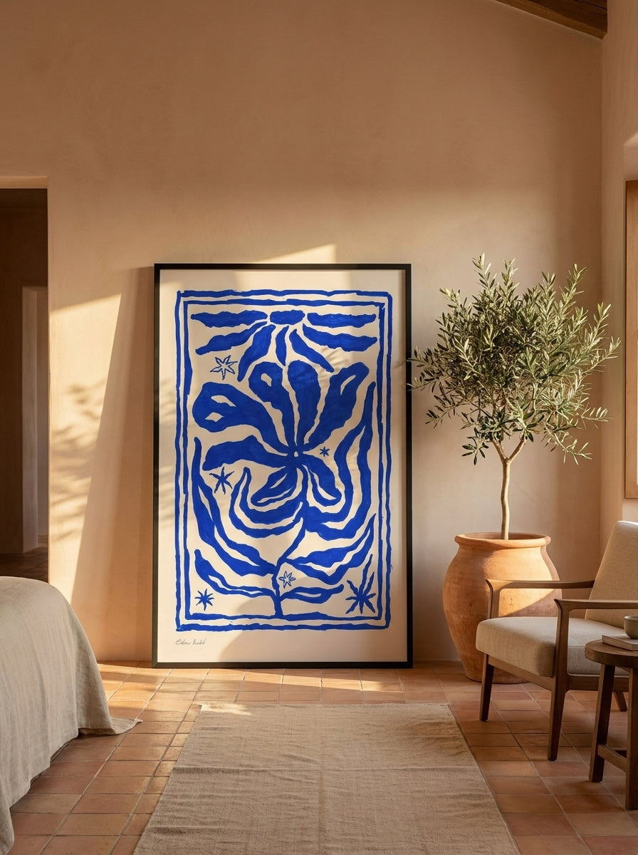 Oversized statement modern wall art print leaning against the wall in a Mediterranean bedroom