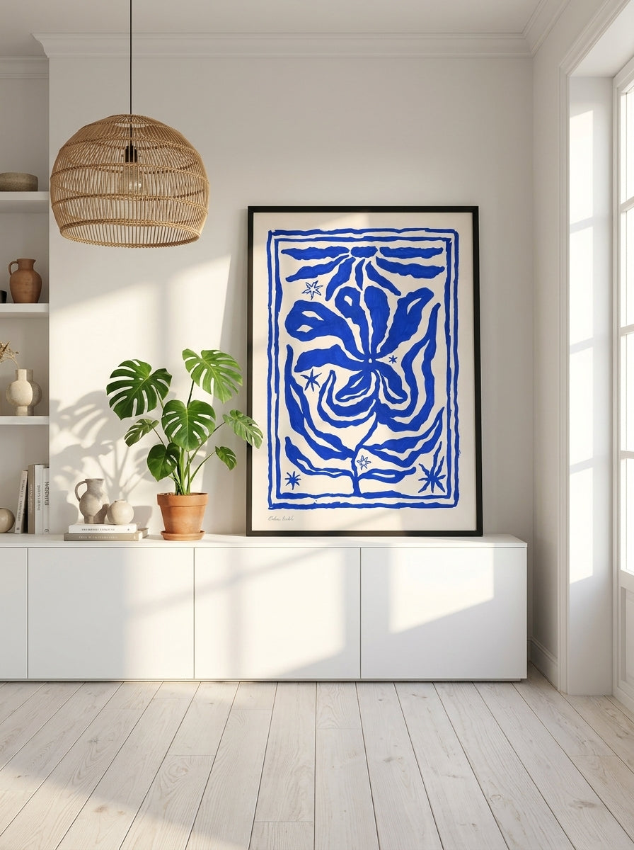 Modern wall art print standing on a sideboard in a bright Scandinavian living room