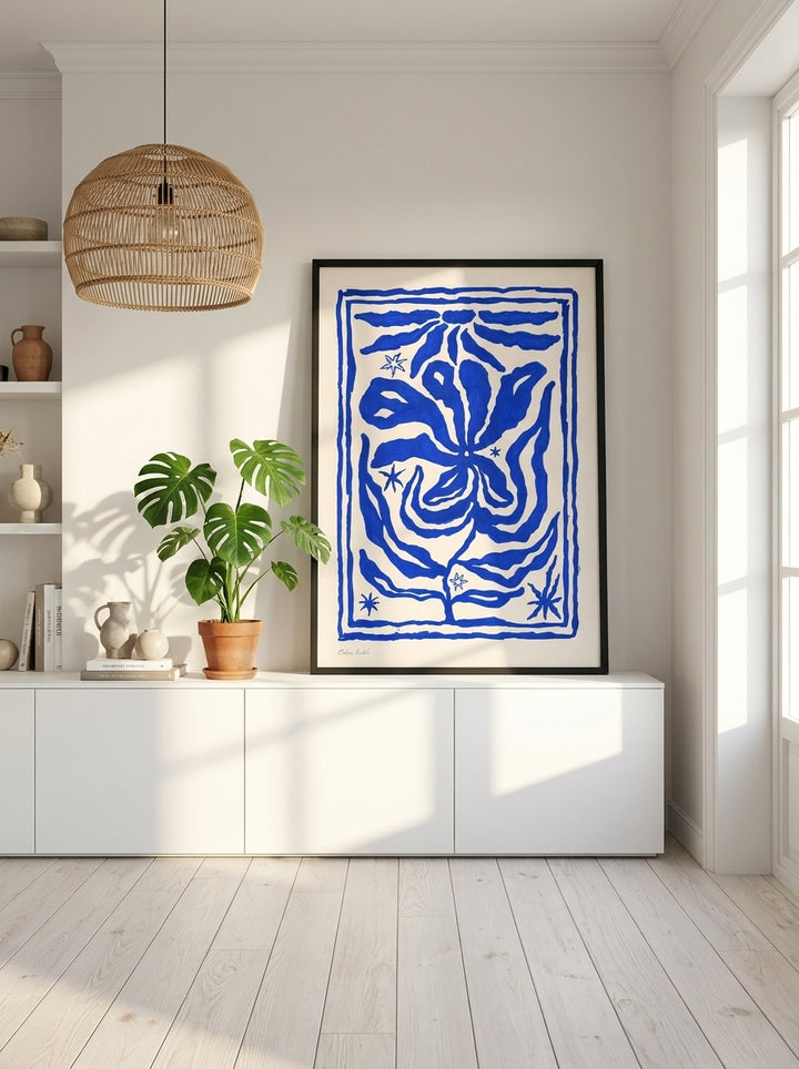 Modern wall art print standing on a sideboard in a bright Scandinavian living room