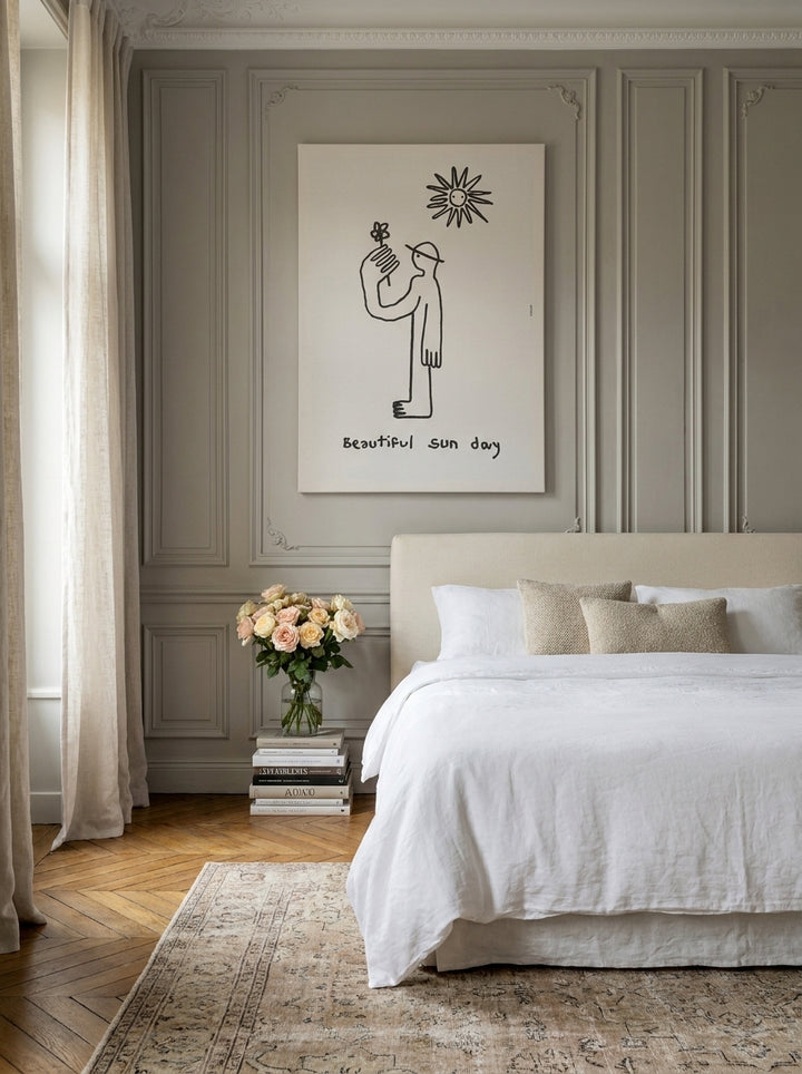 Stretched canvas wall art styled on the wall in a Parisian bedroom