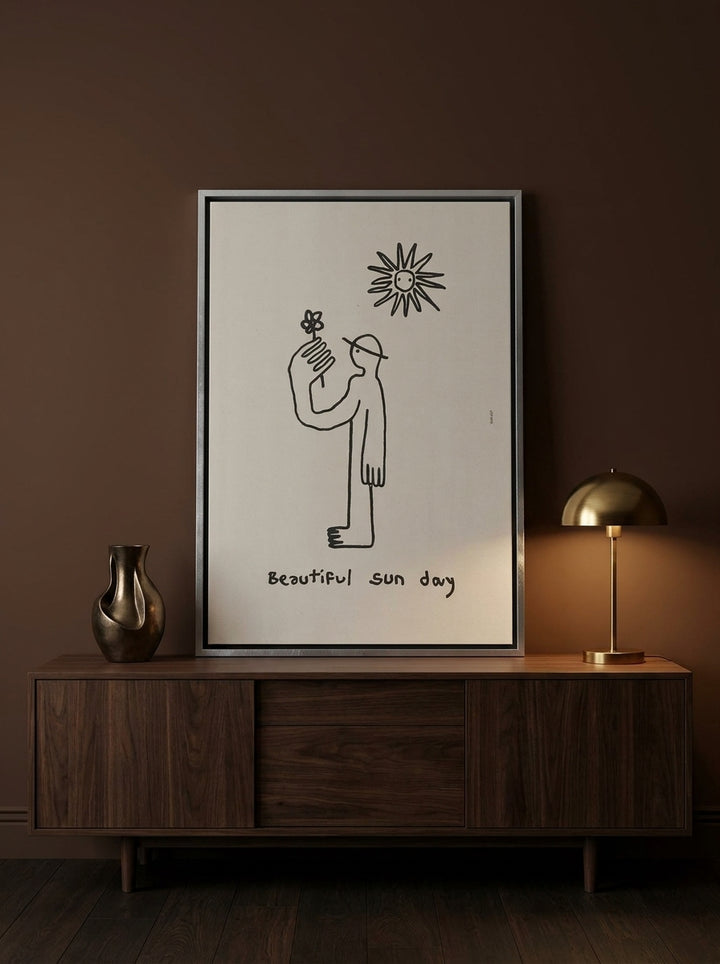 Canvas wall art with a silver leaf surround standing on a sideboard in a moody bedroom