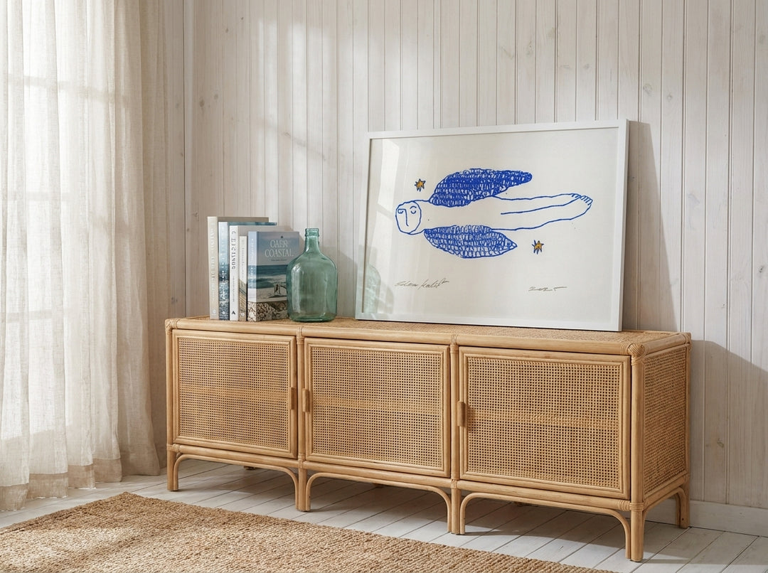 Modern wall art print standing on a sideboard in a coastal nursery