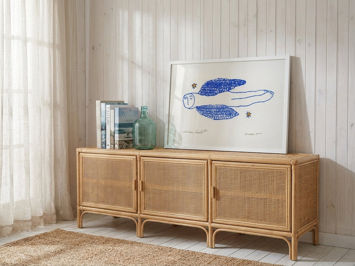 Modern wall art print standing on a sideboard in a coastal nursery