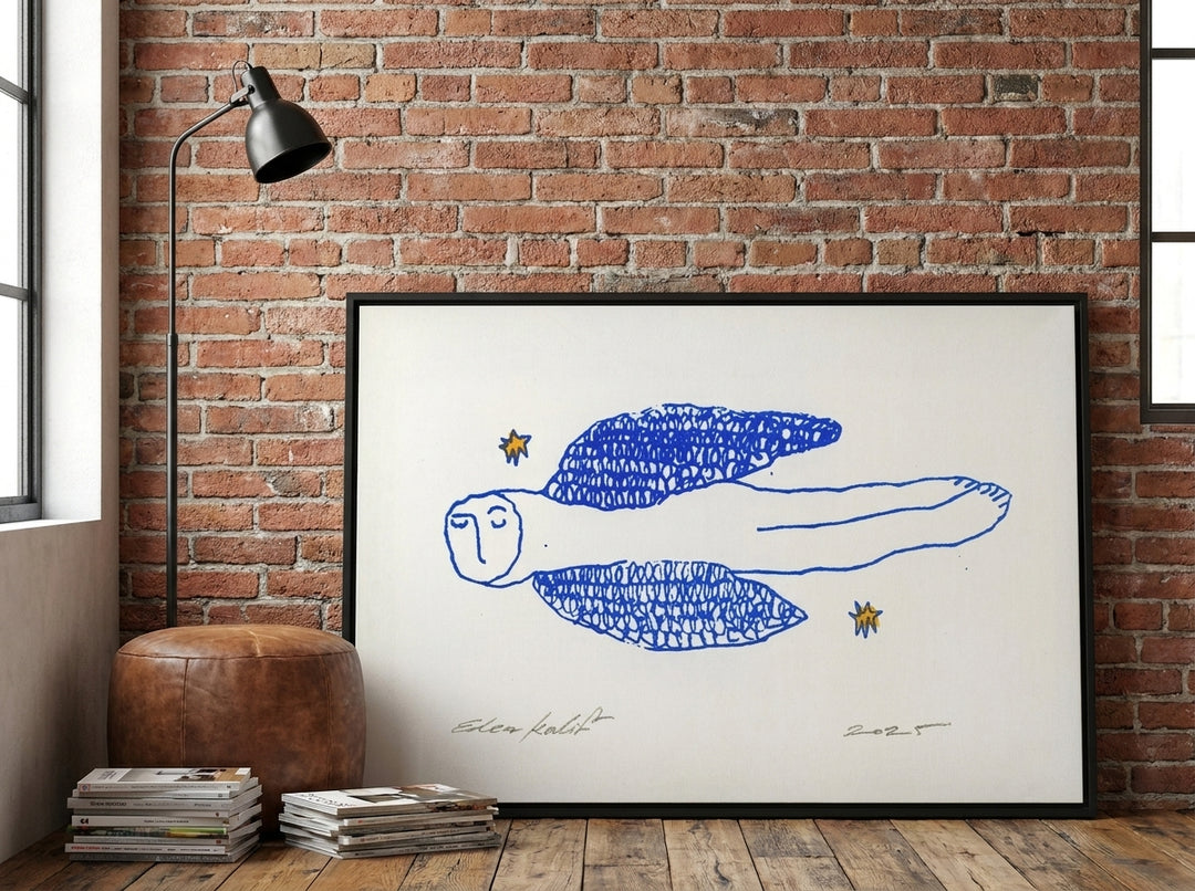 Canvas wall art with a black surround leaning against the wall in an industrial loft home office