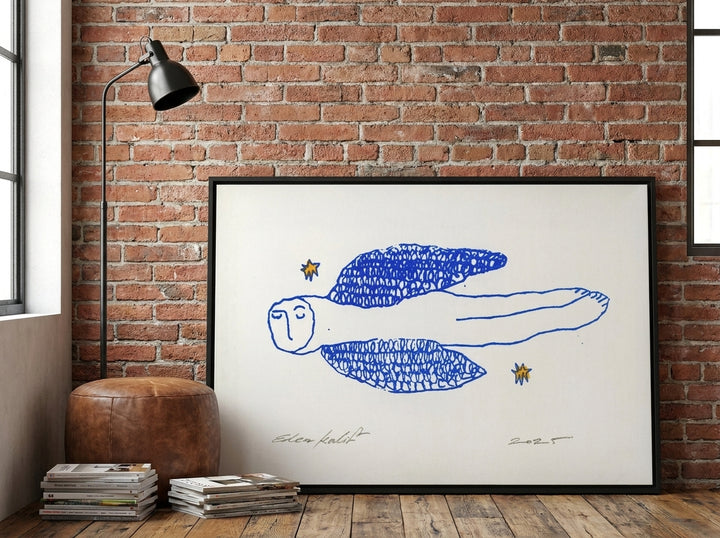 Canvas wall art with a black surround leaning against the wall in an industrial loft home office