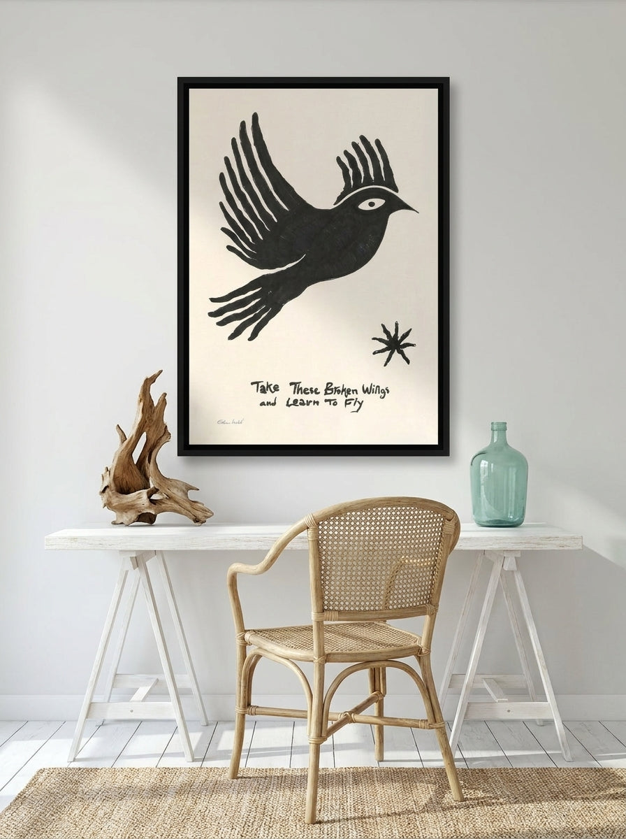 Canvas wall art with a black surround styled on the wall in a coastal home office
