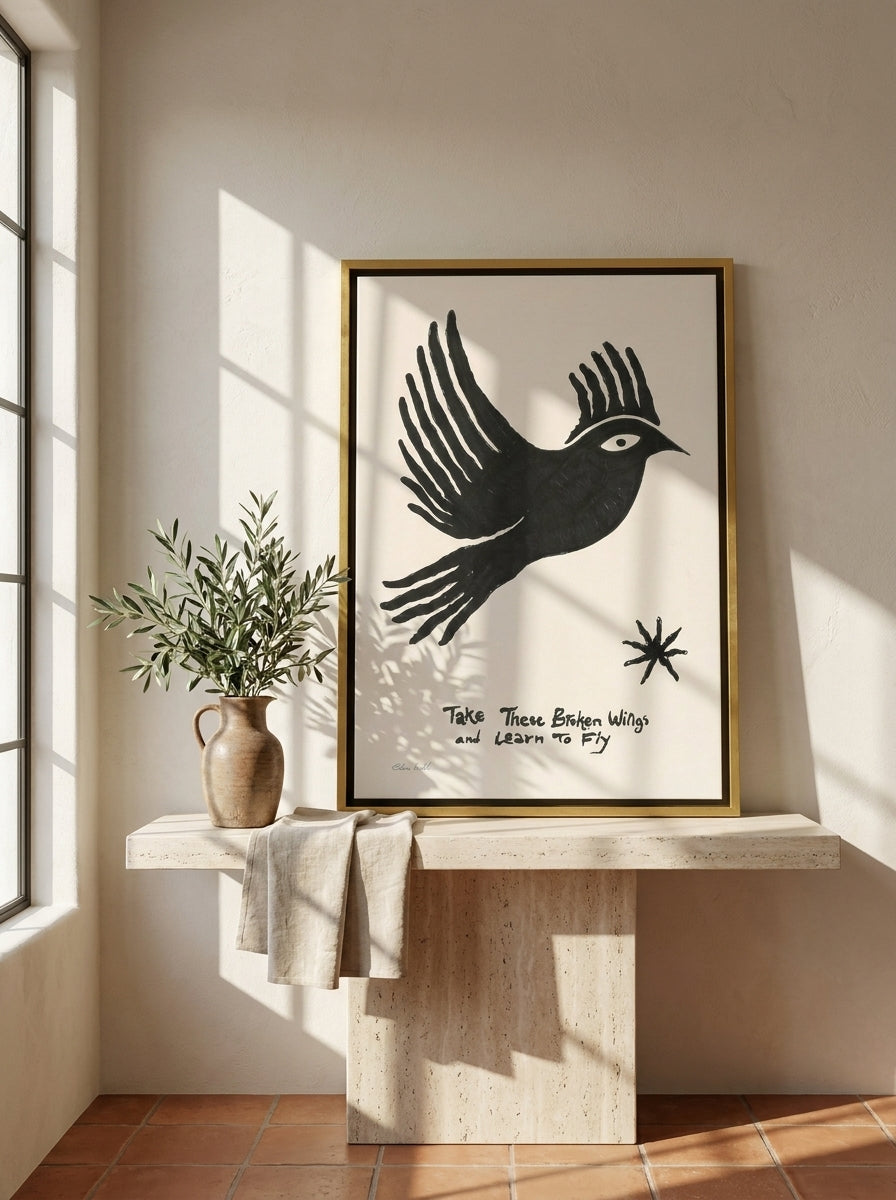 Canvas wall art with a gold leaf surround standing on a console in a Mediterranean bedroom