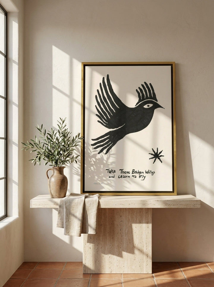 Canvas wall art with a gold leaf surround standing on a console in a Mediterranean bedroom