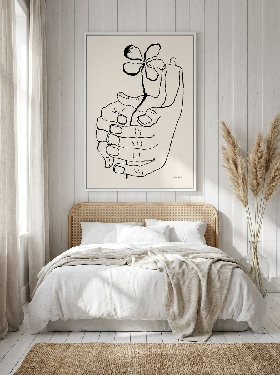 Canvas wall art with a white surround styled on the wall in a coastal bedroom