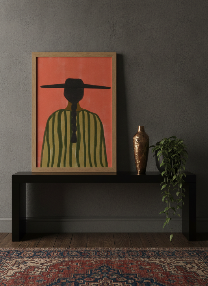 Modern wall art print standing on a console in a moody bedroom