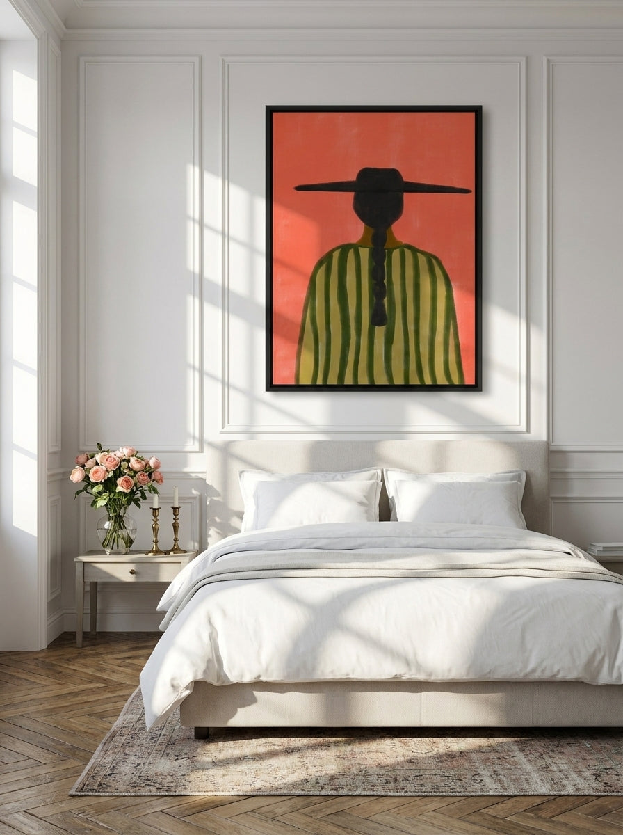 Canvas wall art with a black surround styled on the wall in a Parisian bedroom