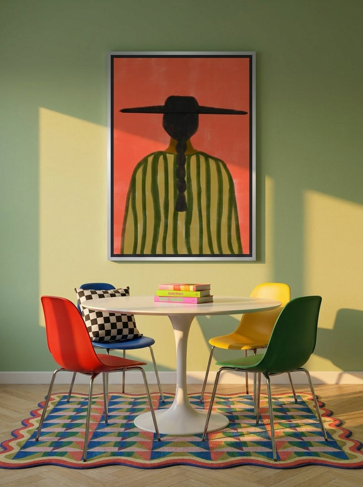 Canvas wall art with a silver leaf surround styled on the wall in a colourful eclectic dining room
