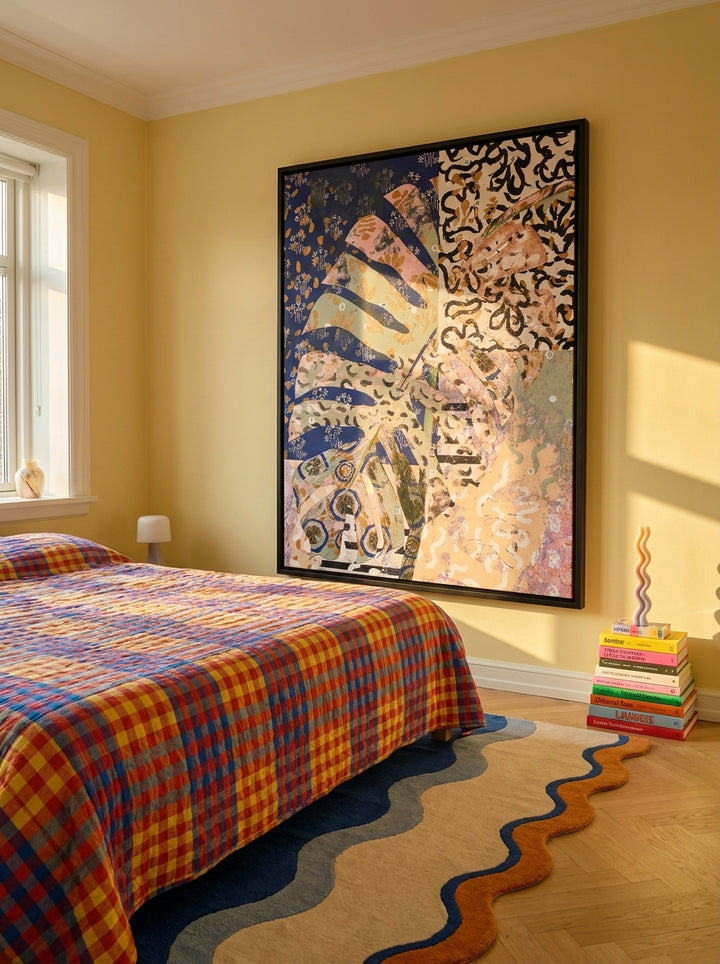 Oversized statement canvas wall art with a black surround styled on the wall in a colourful eclectic bedroom