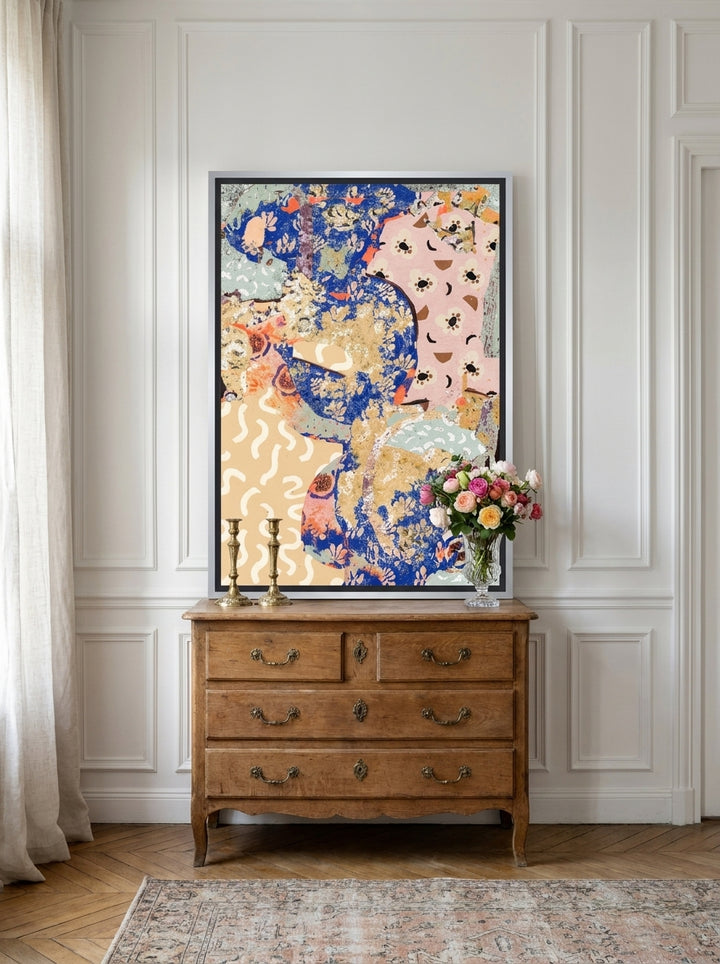 Canvas wall art with a silver leaf surround standing on a sideboard in a Parisian bedroom