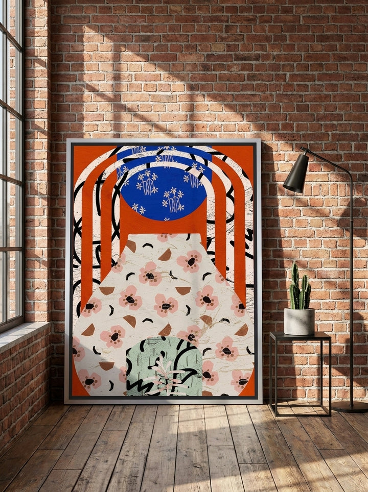 Canvas wall art with a silver leaf surround leaning against the wall in an industrial loft dining room