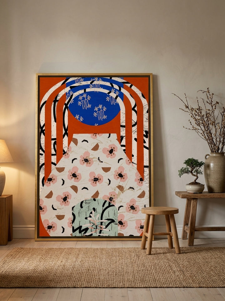 Oversized statement canvas wall art with a gold leaf surround leaning against the wall in a warm Japandi living room