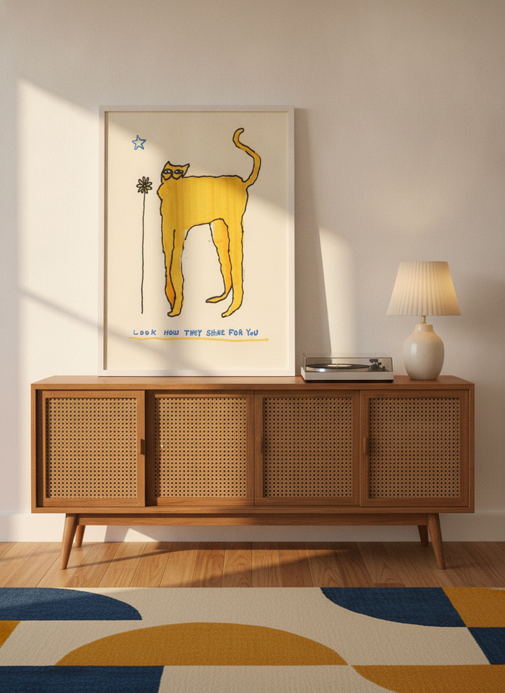 Modern wall art print standing on a sideboard in a mid-century home office