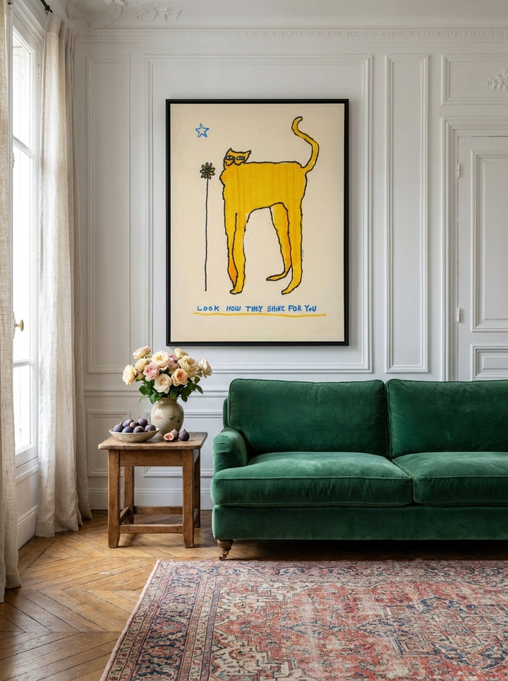 Oversized statement canvas wall art with a black surround styled on the wall in a Parisian living room