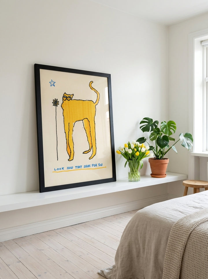 Modern wall art print standing on a shelf in a bright Scandinavian bedroom