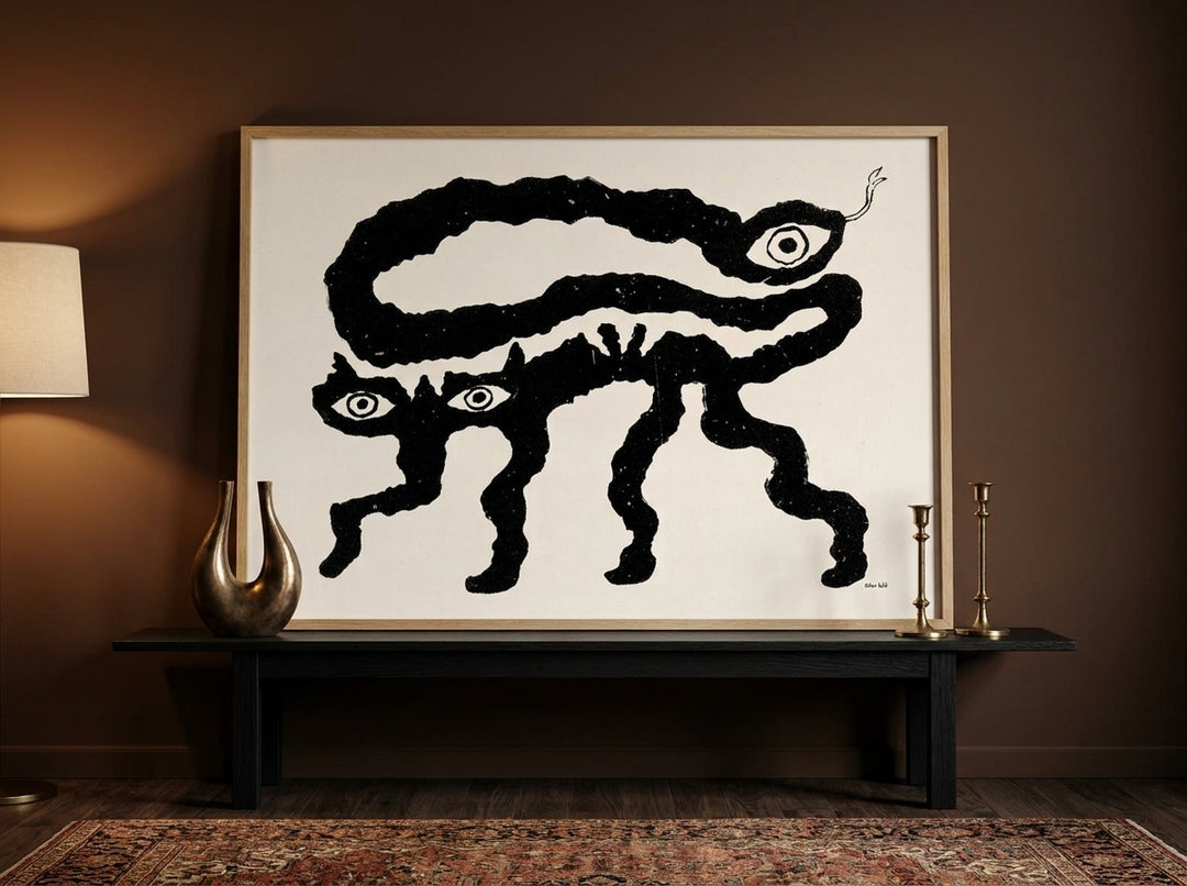 Modern wall art print standing on a console in a moody bedroom