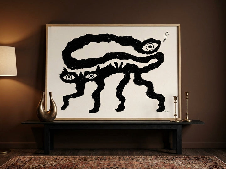 Modern wall art print standing on a console in a moody bedroom
