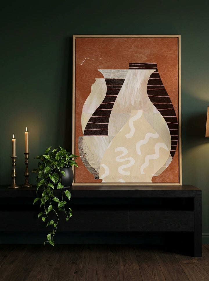 Canvas wall art with a natural timber surround standing on a console in a moody bedroom