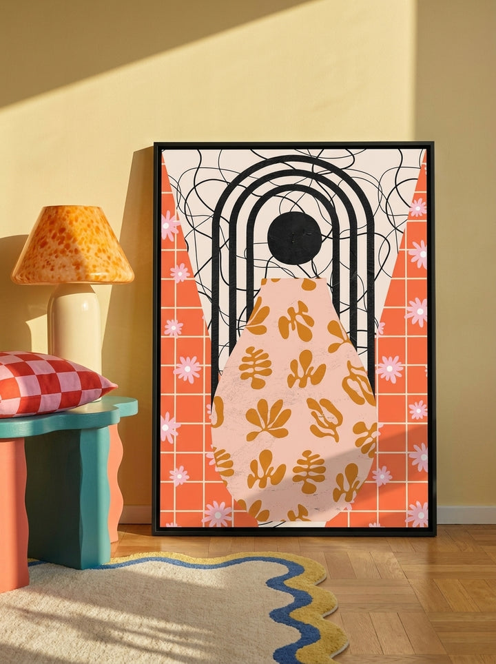 Canvas wall art with a black surround leaning against the wall in a colourful eclectic bedroom
