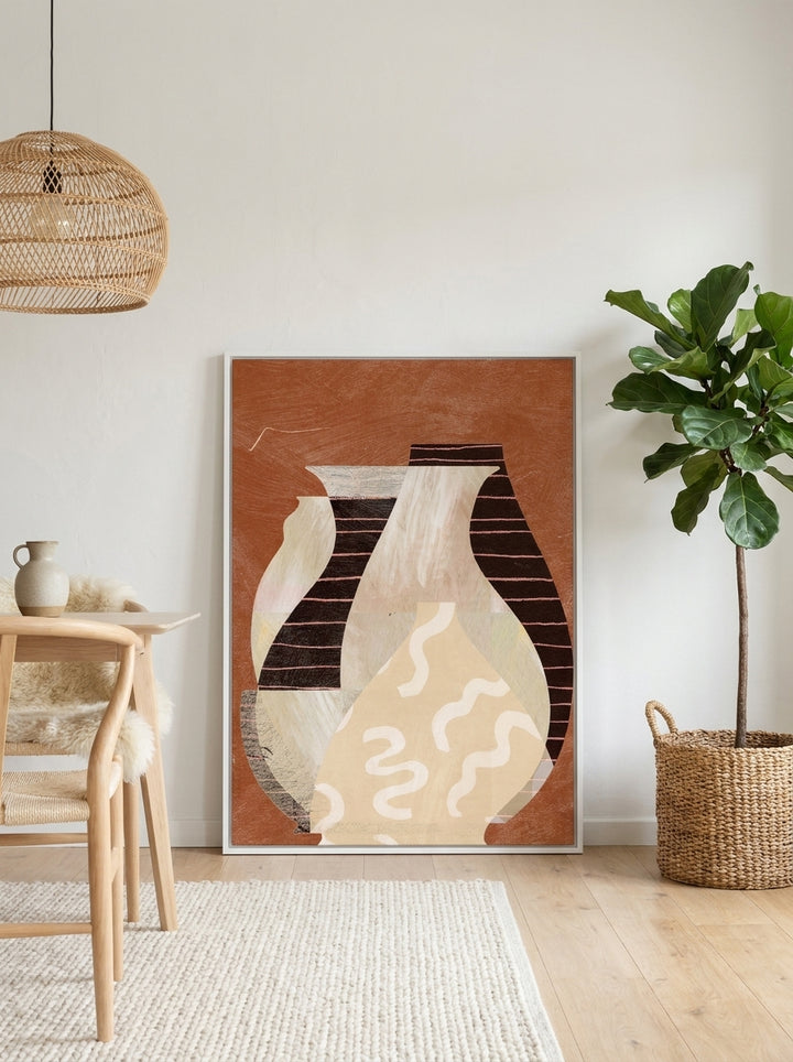 Canvas wall art with a white surround leaning against the wall in a bright Scandinavian dining room