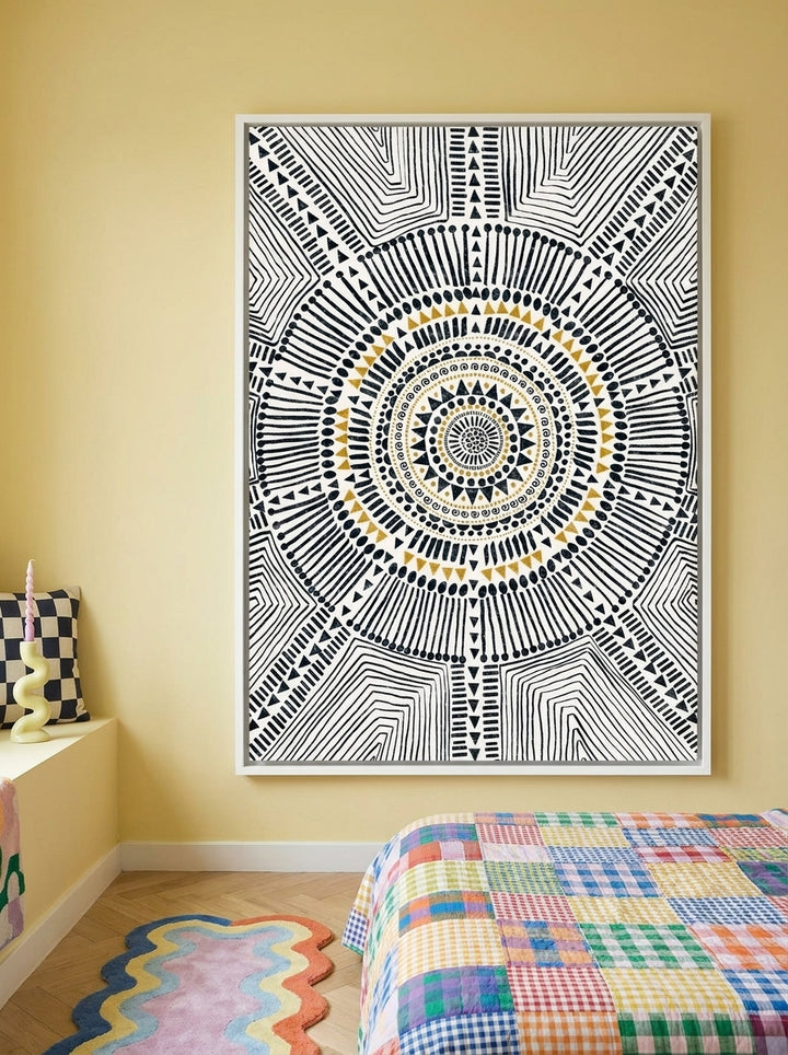 Canvas wall art with a white surround styled on the wall in a colourful eclectic bedroom