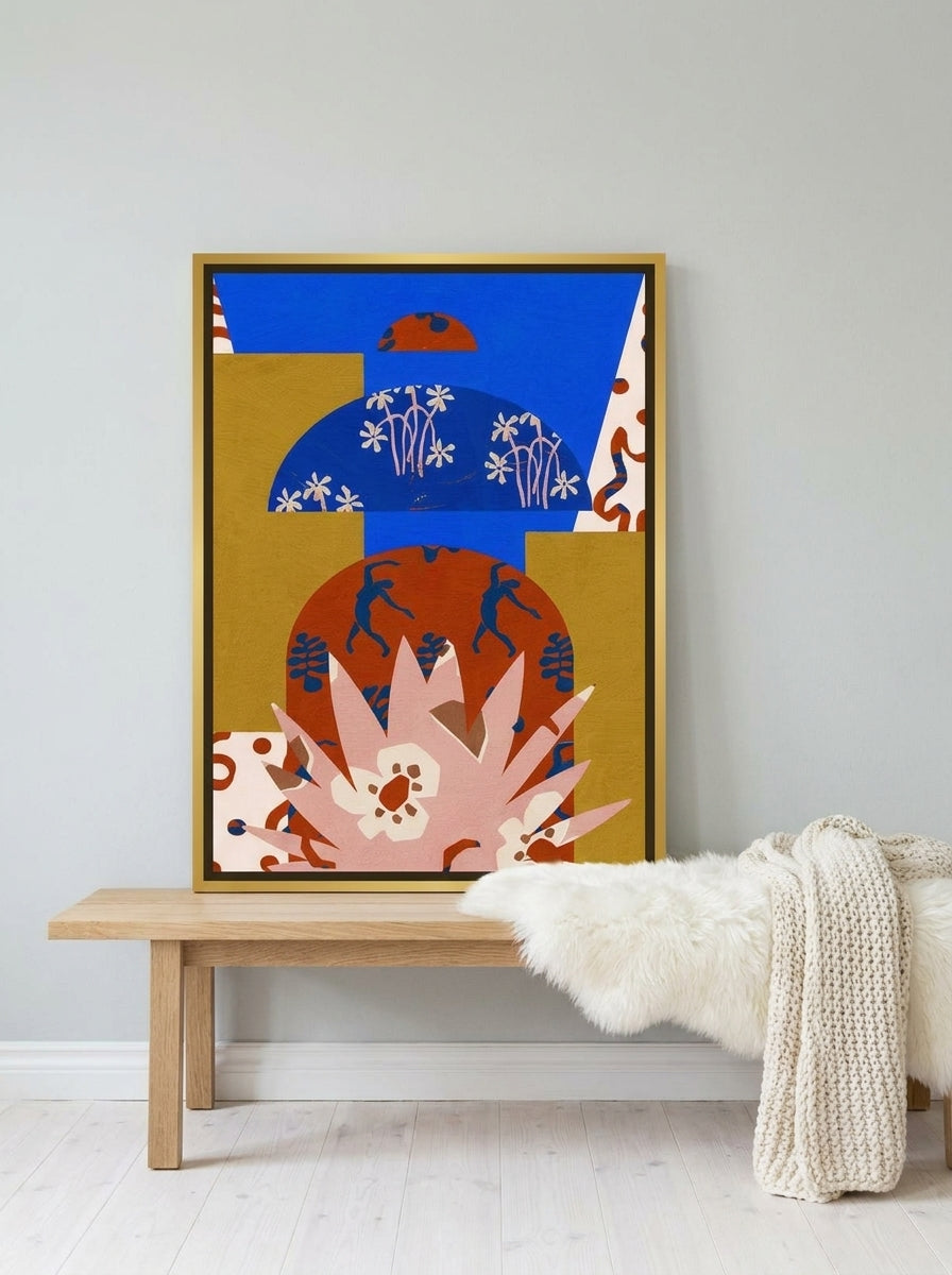 Canvas wall art with a gold leaf surround standing on a bench in a bright Scandinavian living room