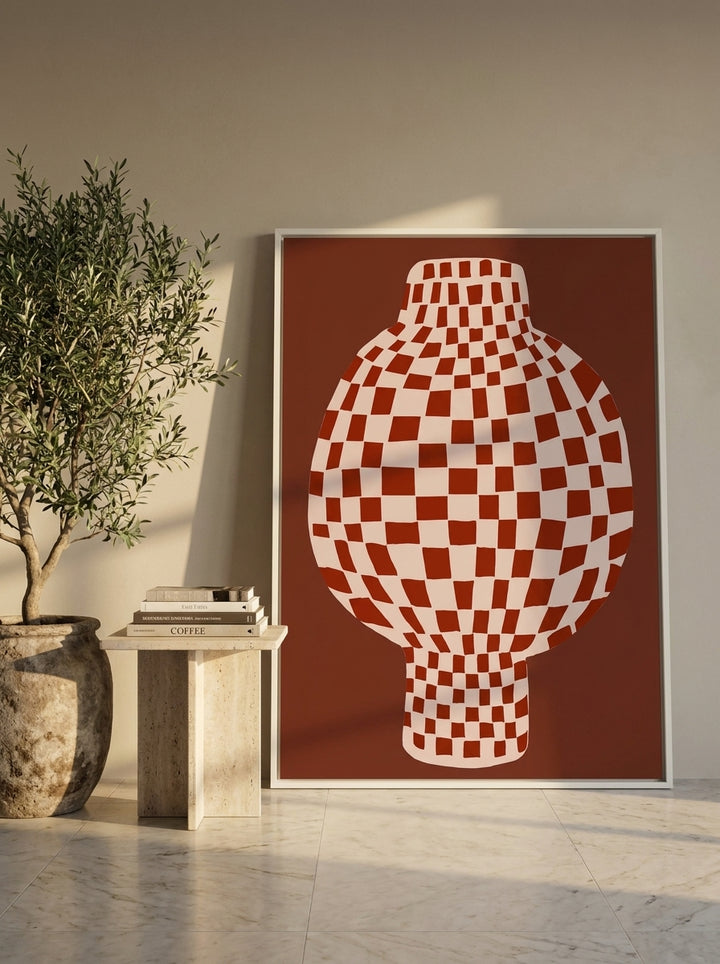 Oversized statement canvas wall art with a white surround leaning against the wall in a luxe dining room