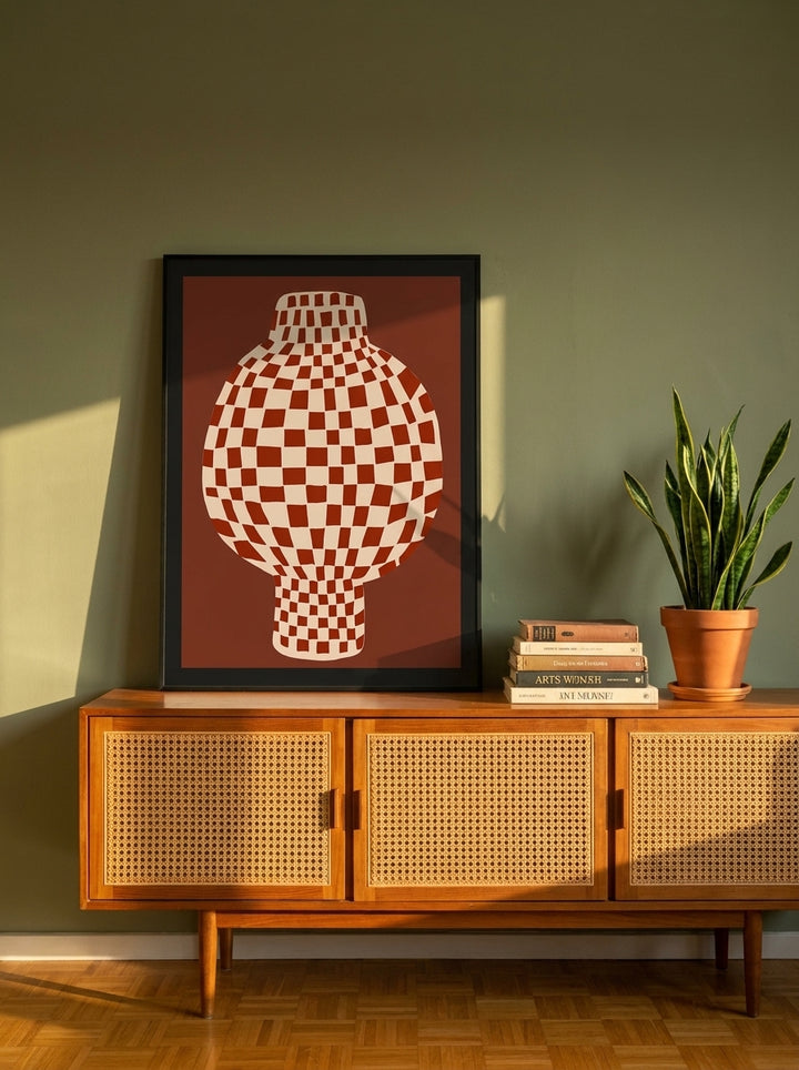 Modern wall art print standing on a sideboard in a mid-century living room