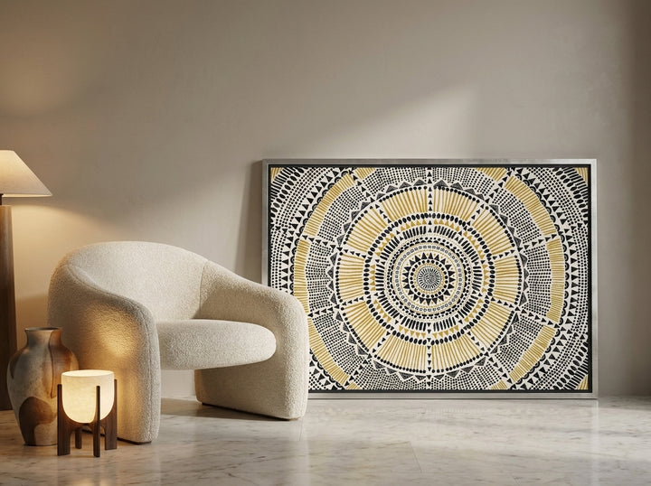 Canvas wall art with a silver leaf surround leaning against the wall in a luxe bedroom