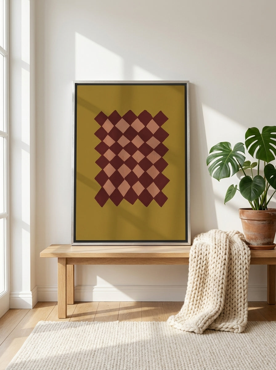 Canvas wall art with a silver leaf surround standing on a bench in a bright Scandinavian home office