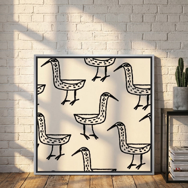 Canvas wall art with a silver leaf surround leaning against the wall in an industrial loft home office