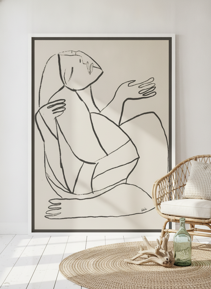 Oversized statement canvas wall art with a white surround leaning against the wall in a coastal living room