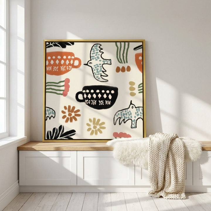 Canvas wall art with a gold leaf surround standing on a kitchen bench in a bright Scandinavian kitchen