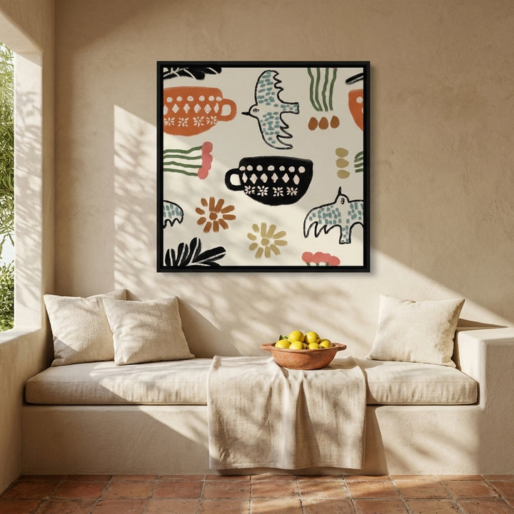 Canvas wall art with a black surround styled on the wall in a Mediterranean living room