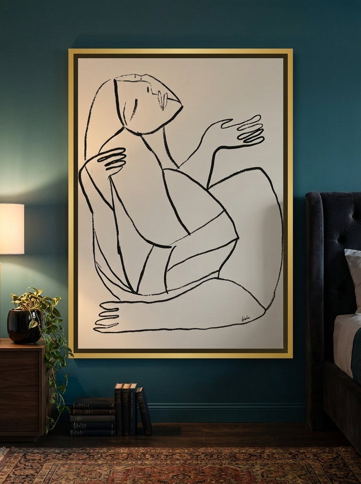 Canvas wall art with a gold leaf surround styled on the wall in a moody bedroom