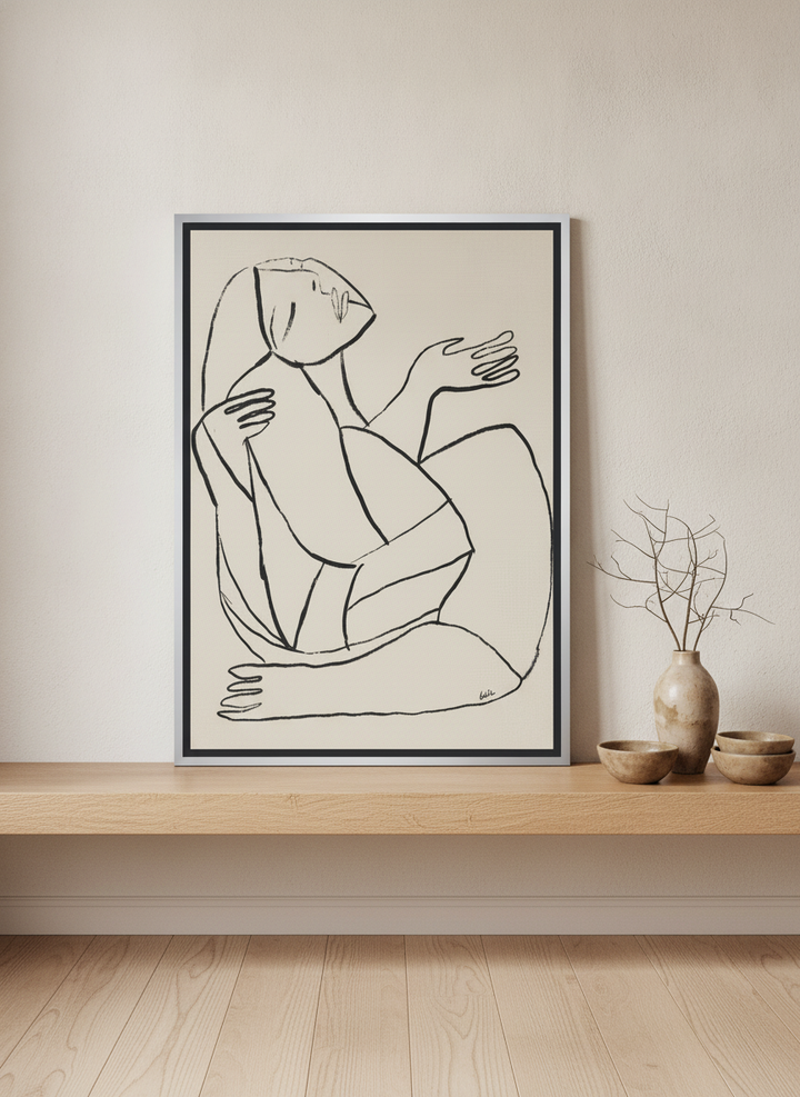 Canvas wall art with a silver leaf surround standing on a shelf in a warm Japandi home office