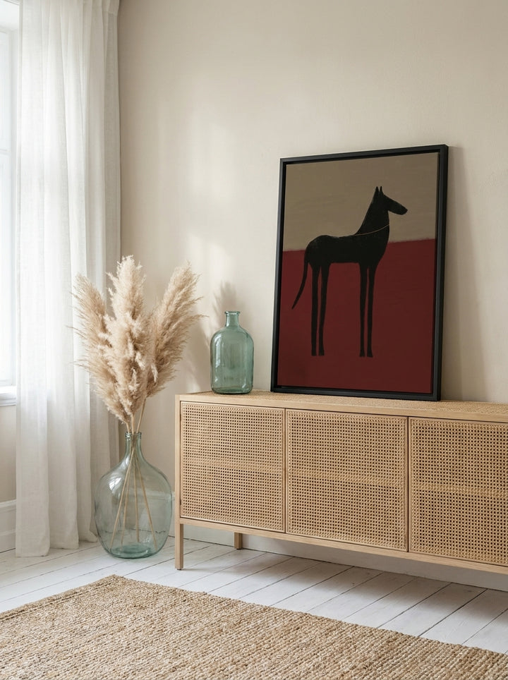 Canvas wall art with a black surround standing on a sideboard in a coastal living room