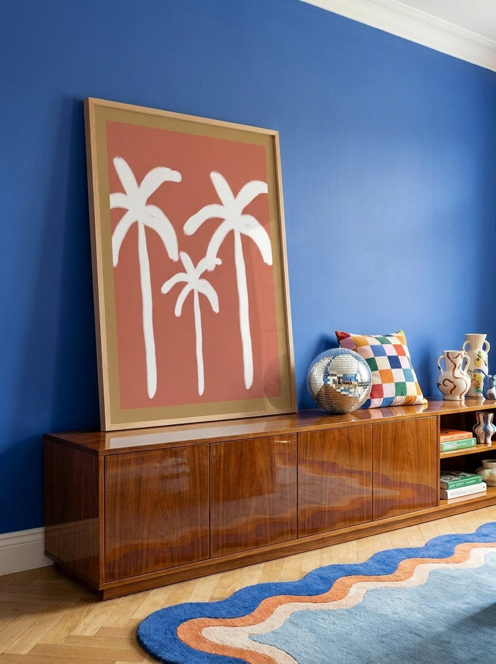 Modern wall art print standing on a sideboard in a colourful eclectic dining room