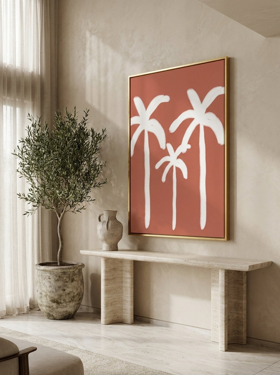 Oversized statement canvas wall art with a gold leaf surround styled on the wall in a luxe living room