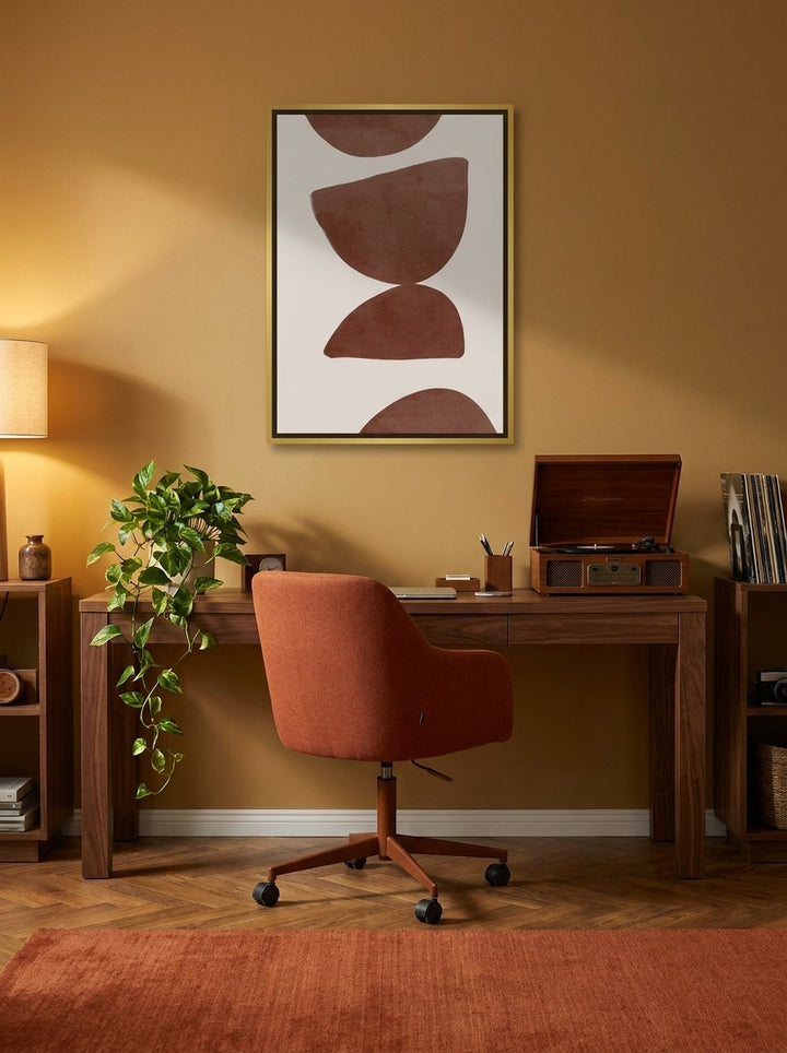 Canvas wall art with a gold leaf surround styled on the wall in a retro 70s home office