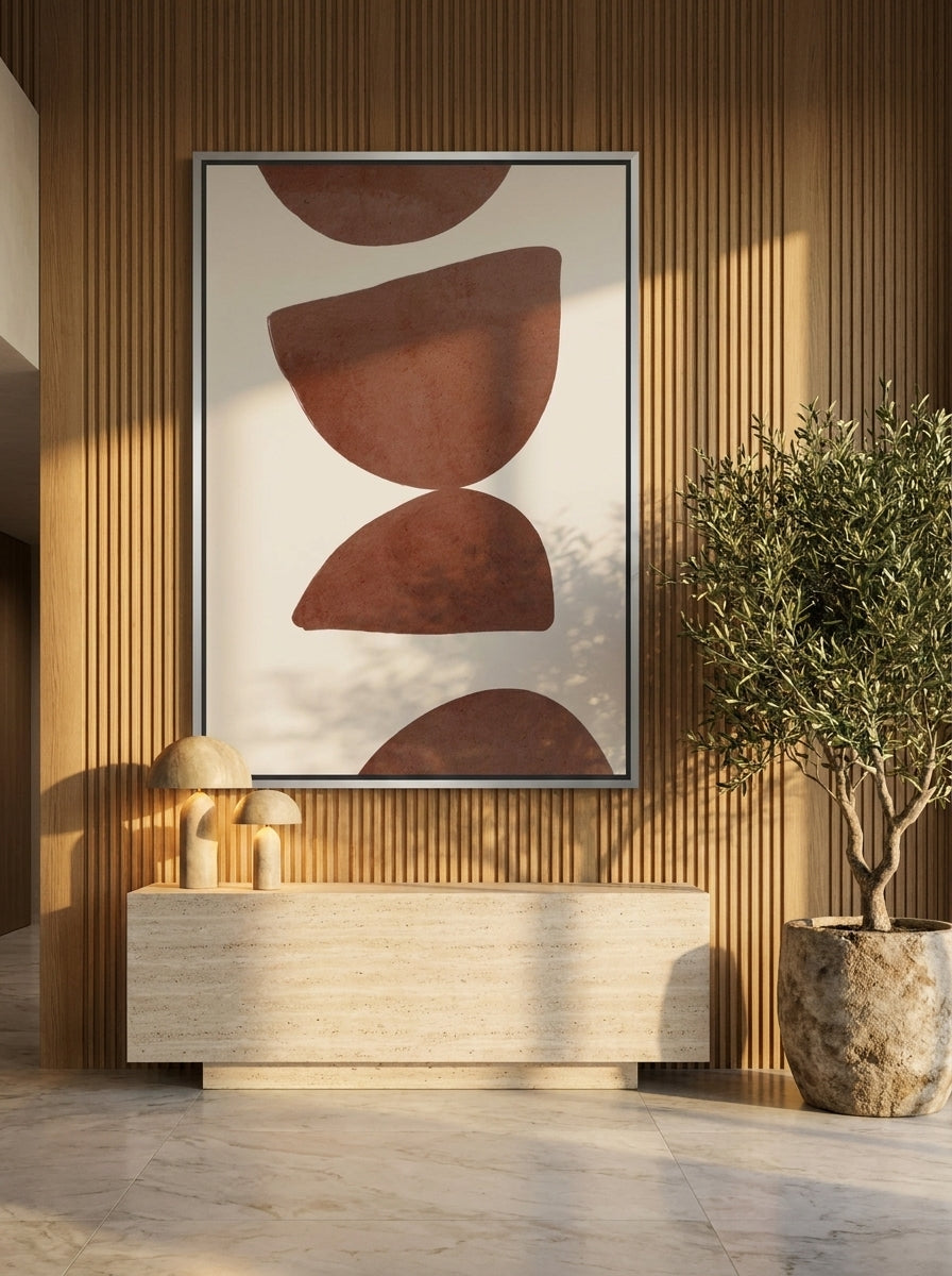 Oversized statement canvas wall art with a silver leaf surround styled on the wall in a luxe living room