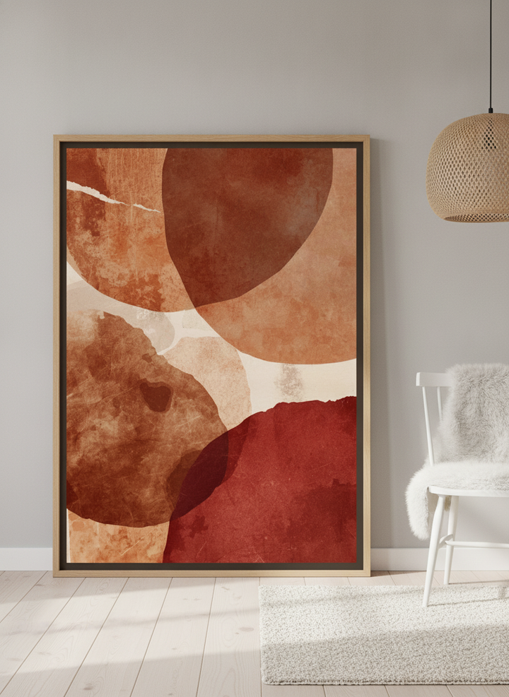 Oversized statement canvas wall art with a natural timber surround leaning against the wall in a bright Scandinavian dining room