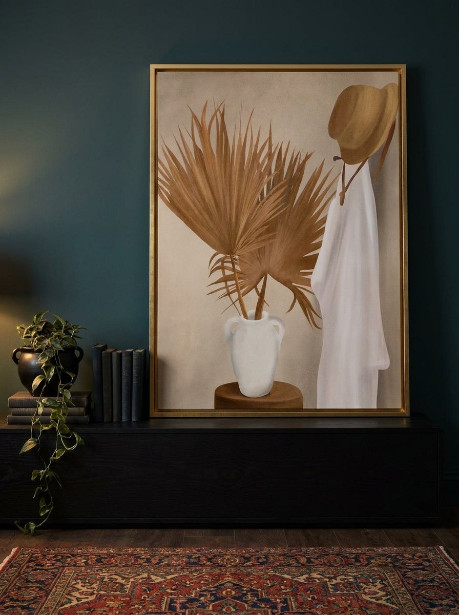 Canvas wall art with a gold leaf surround standing on a console in a moody bedroom