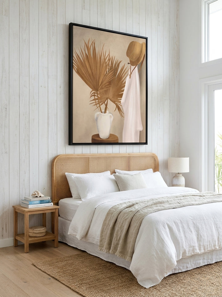 Oversized statement canvas wall art with a black surround styled on the wall in a coastal bedroom